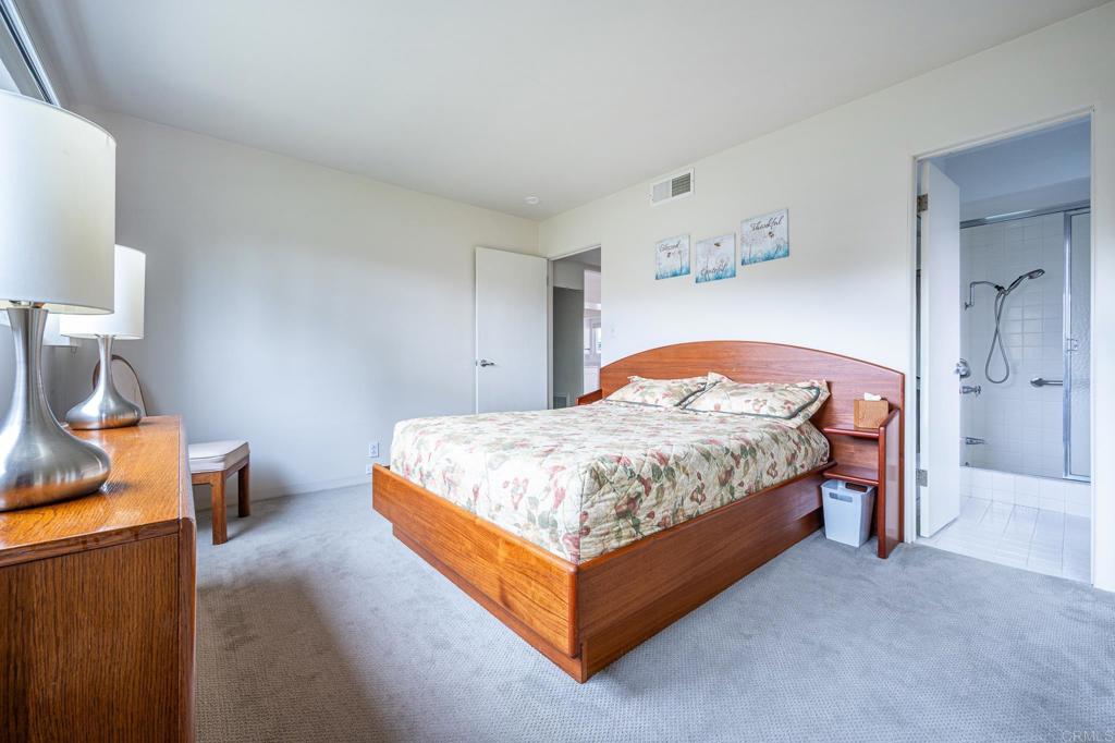 69850 Highway 111, Unit 18 Rancho Mirage, CA 92270 - Photo 20 of 41 a bedroom with a bed and a lamp