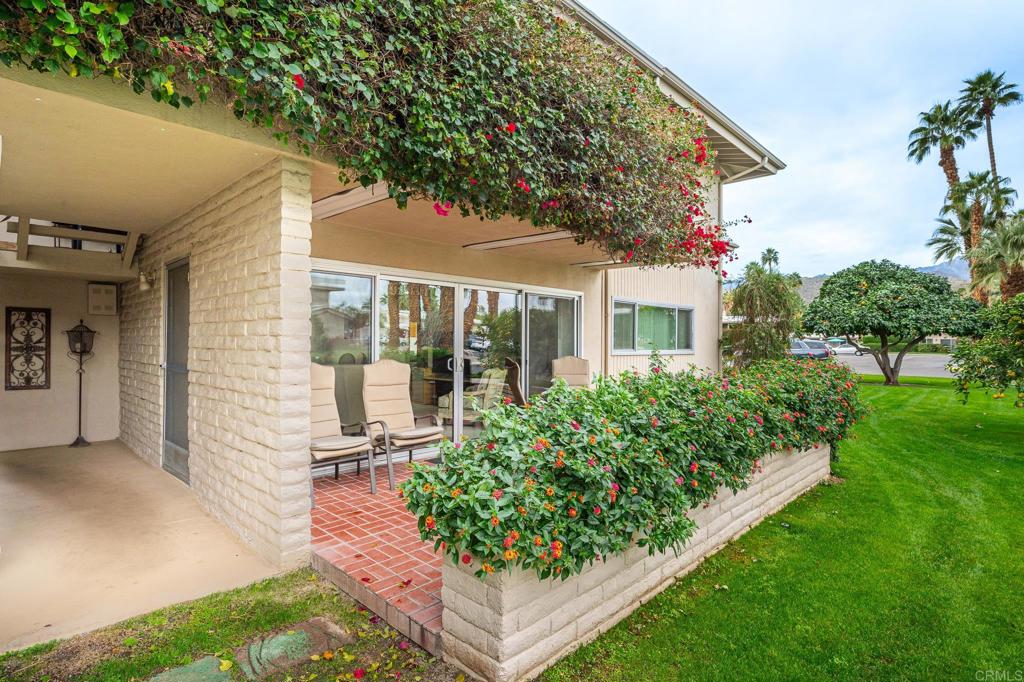 69850 Highway 111, Unit 18 Rancho Mirage, CA 92270 - Photo 2 of 41 a front view of a house with garden