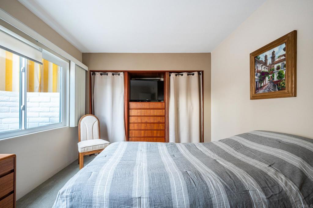 69850 Highway 111, Unit 18 Rancho Mirage, CA 92270 - Photo 24 of 41 a bedroom with a bed and a large window