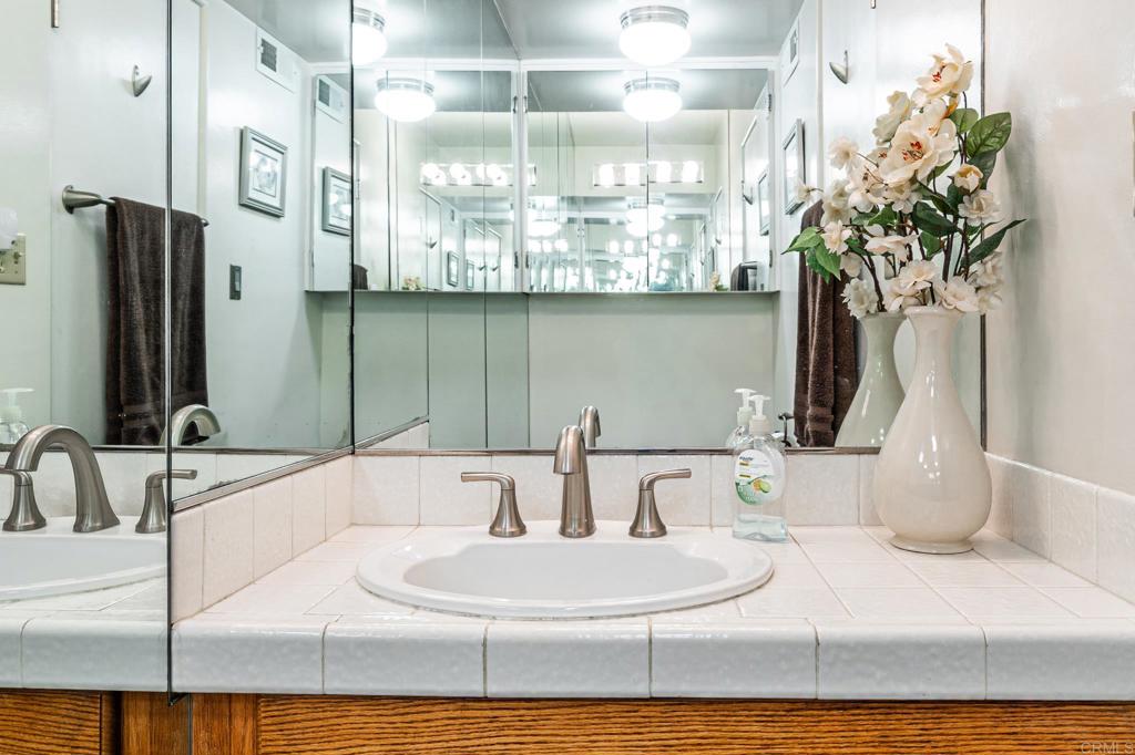 69850 Highway 111, Unit 18 Rancho Mirage, CA 92270 - Photo 27 of 41 a bathroom with a double vanity sink and a mirror