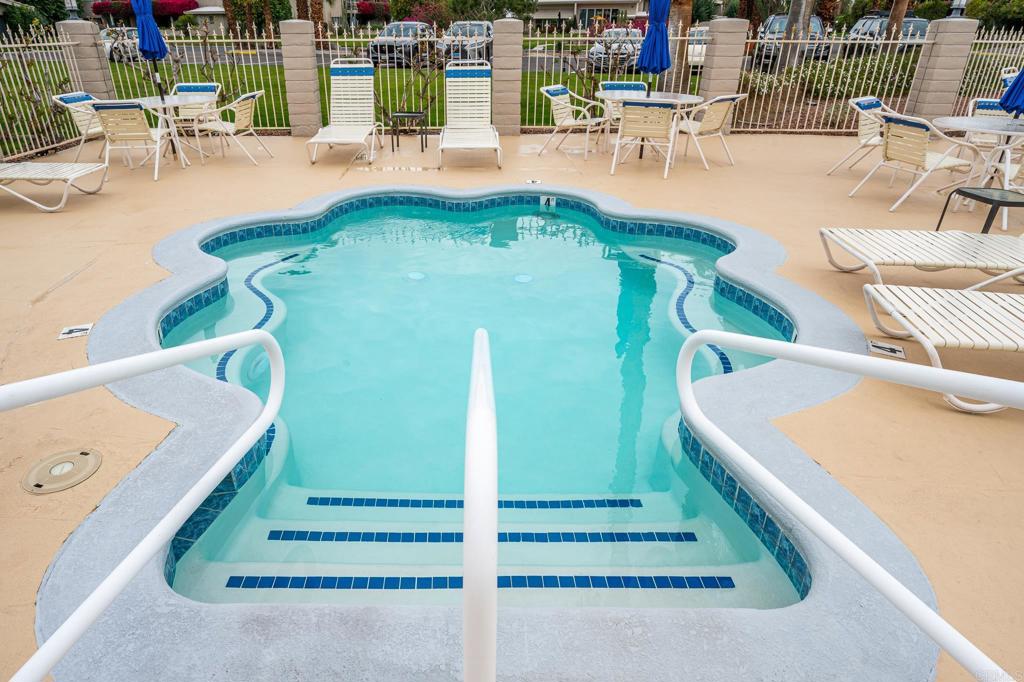 69850 Highway 111, Unit 18 Rancho Mirage, CA 92270 - Photo 28 of 41 a view of a swimming pool with outdoor seating and plants