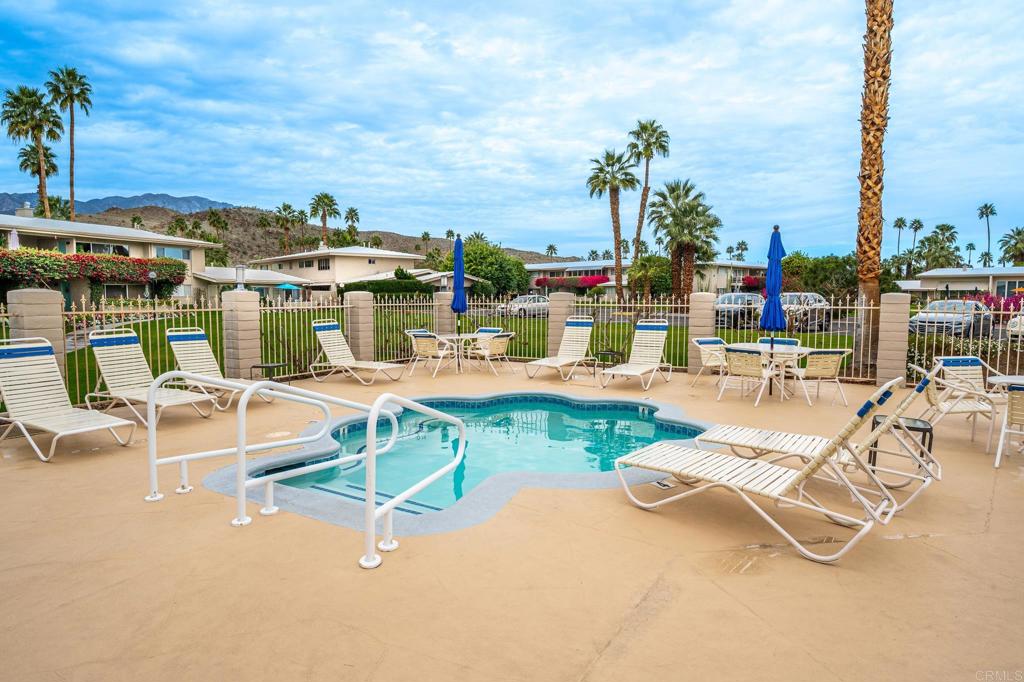 69850 Highway 111, Unit 18 Rancho Mirage, CA 92270 - Photo 34 of 41 a view of a swimming pool with a lawn chairs