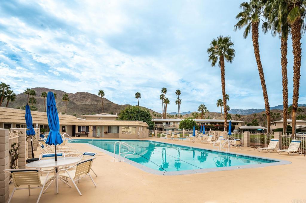 69850 Highway 111, Unit 18 Rancho Mirage, CA 92270 - Photo 40 of 41 a view of a swimming pool with a lawn chairs under an umbrella
