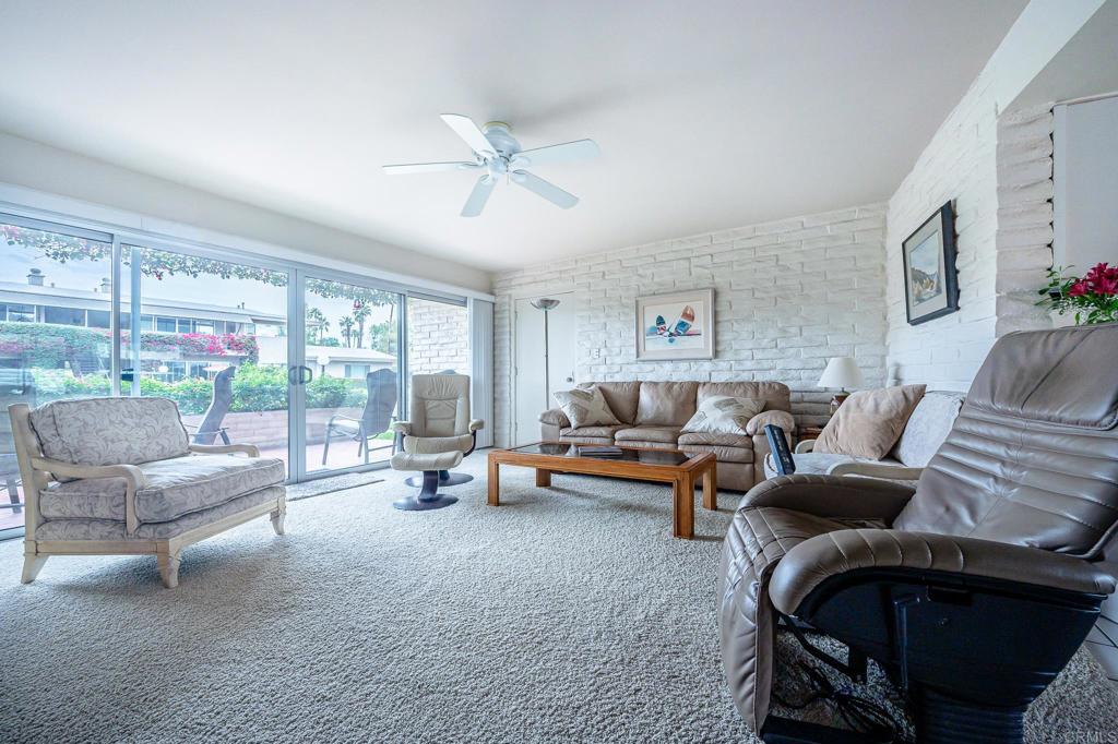 69850 Highway 111, Unit 18 Rancho Mirage, CA 92270 - Photo 8 of 41 a living room with furniture and a floor to ceiling window
