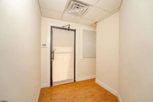 a view of a hallway with a wooden shelves