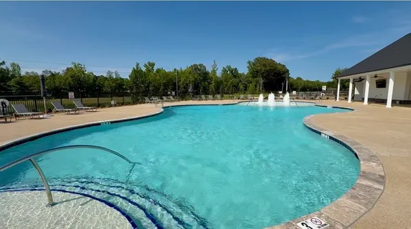 a view of a swimming pool with a patio