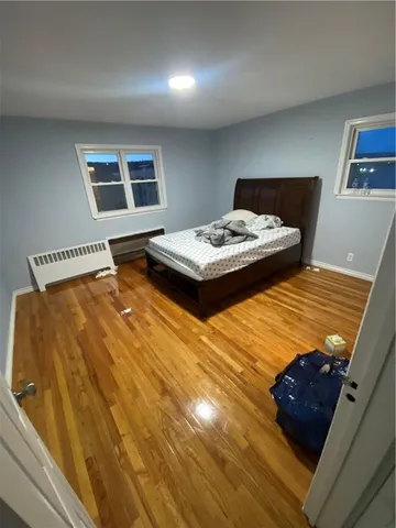 a bedroom with a bed and a lamp with window