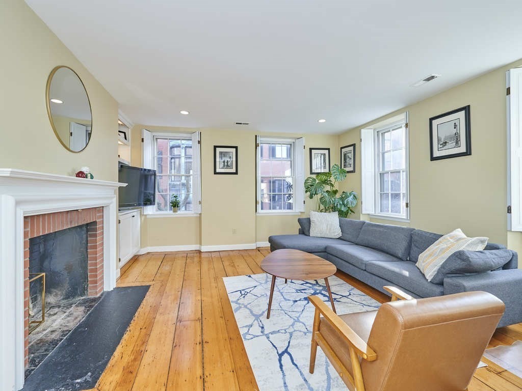 65 Pinckney Street, Unit 3 Boston, MA 02114 - Photo 1 of 14 a living room with furniture and a fireplace