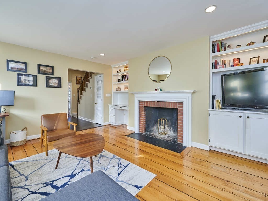 65 Pinckney Street, Unit 3 Boston, MA 02114 - Photo 3 of 14 a living room with furniture and a fireplace