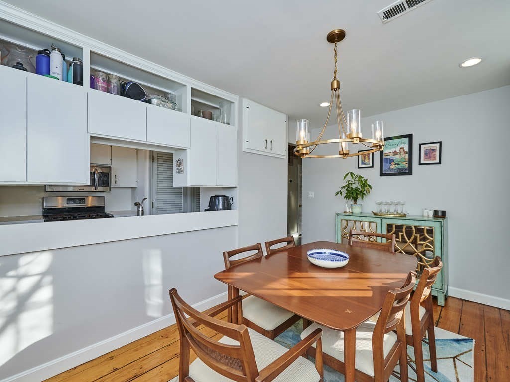 65 Pinckney Street, Unit 3 Boston, MA 02114 - Photo 5 of 14 a kitchen with stainless steel appliances granite countertop a dining table and chairs