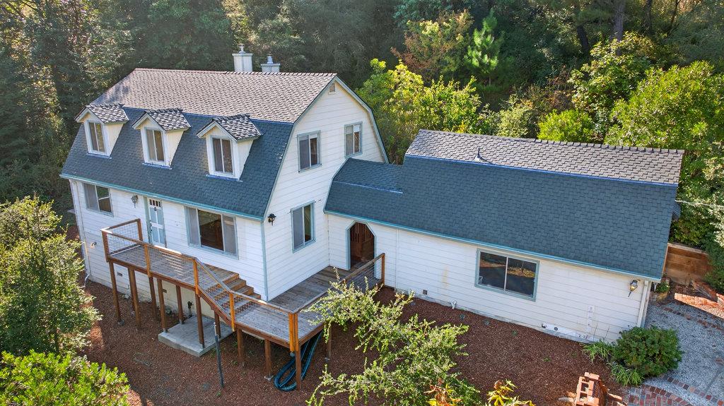 an aerial view of a house with a yard