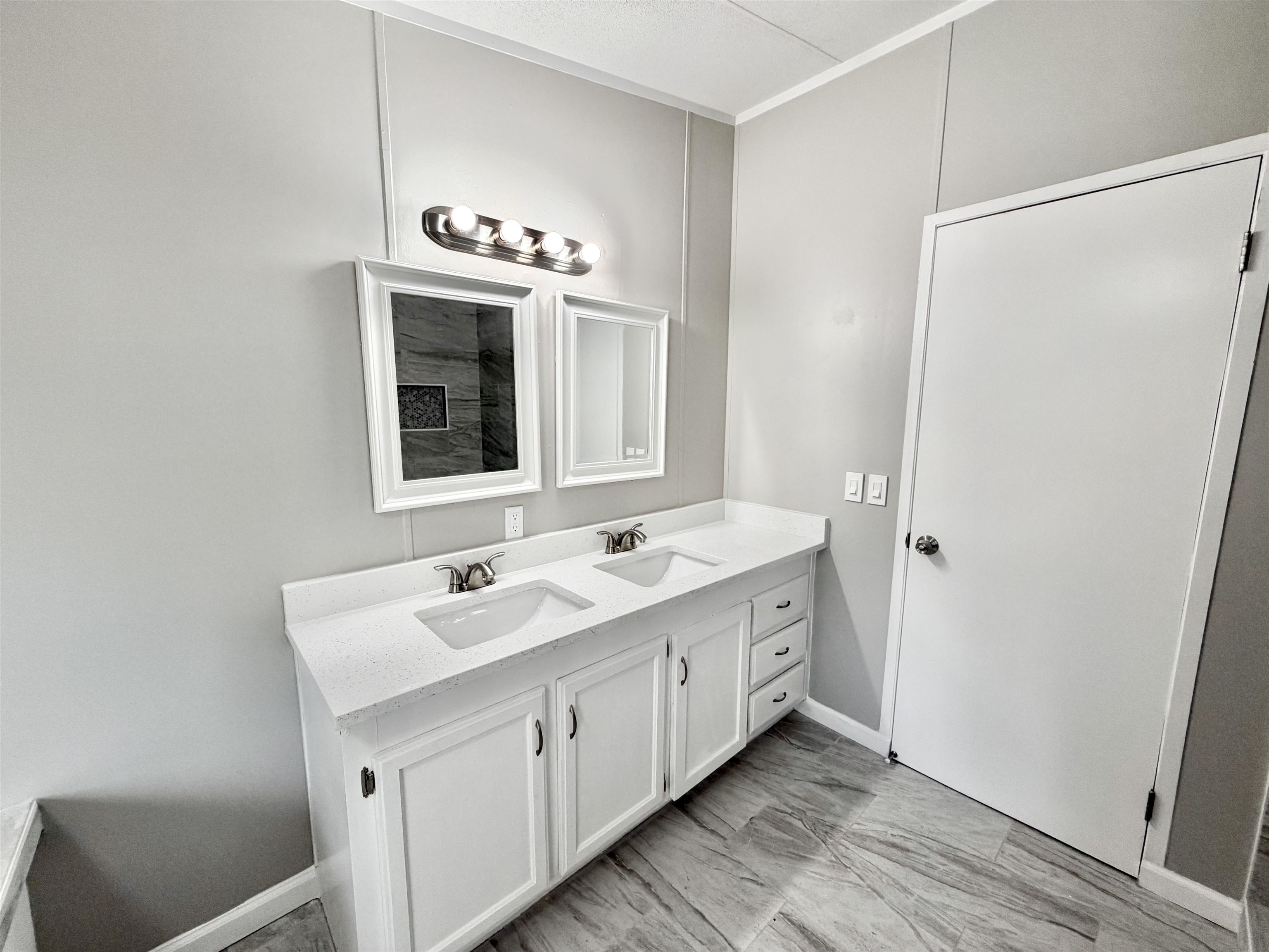 1655 Fayne Road Brighton, TN 38011 - Photo 24 of 28 Double vanity featuring white cabinetry, integrated sinks, and a light-toned countertop