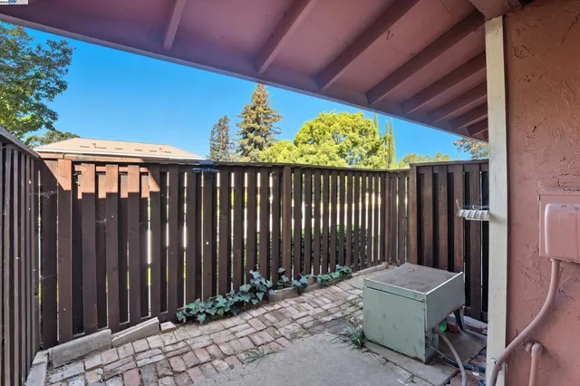 a backyard of a house with wooden fence