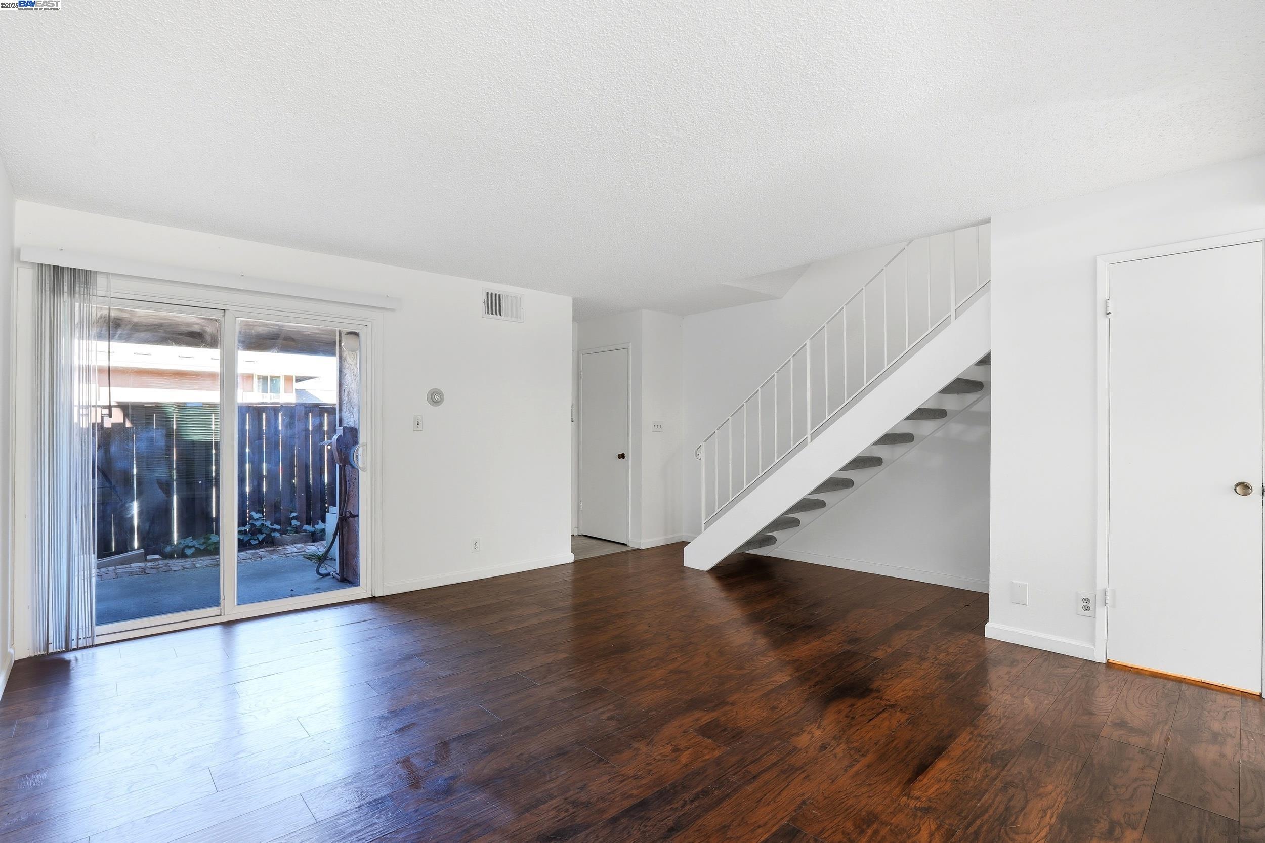 2067 Olivera Road, Unit B Concord, CA 94520 - Photo 2 of 23 wooden floor in an empty room with a window