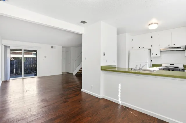 a view of a kitchen with wooden floor