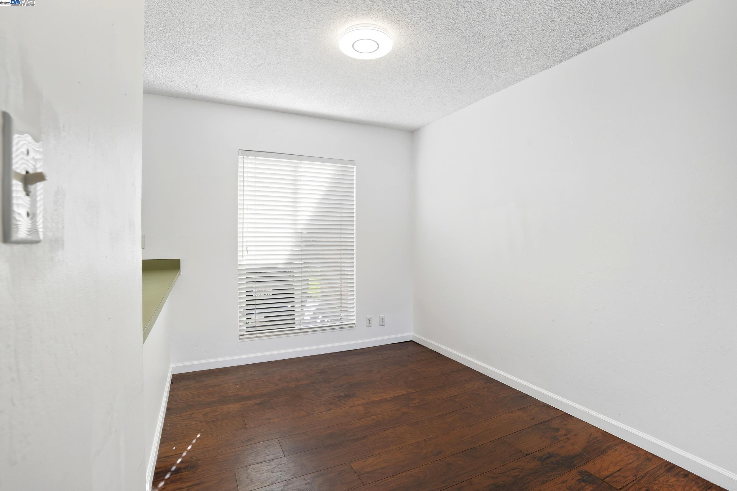 2067 Olivera Road, Unit B Concord, CA 94520 - Photo 5 of 23 an empty room with wooden floor and windows