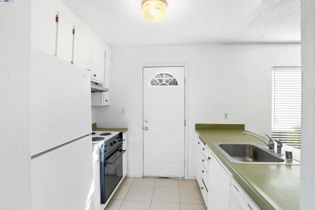 a kitchen with a refrigerator and a sink