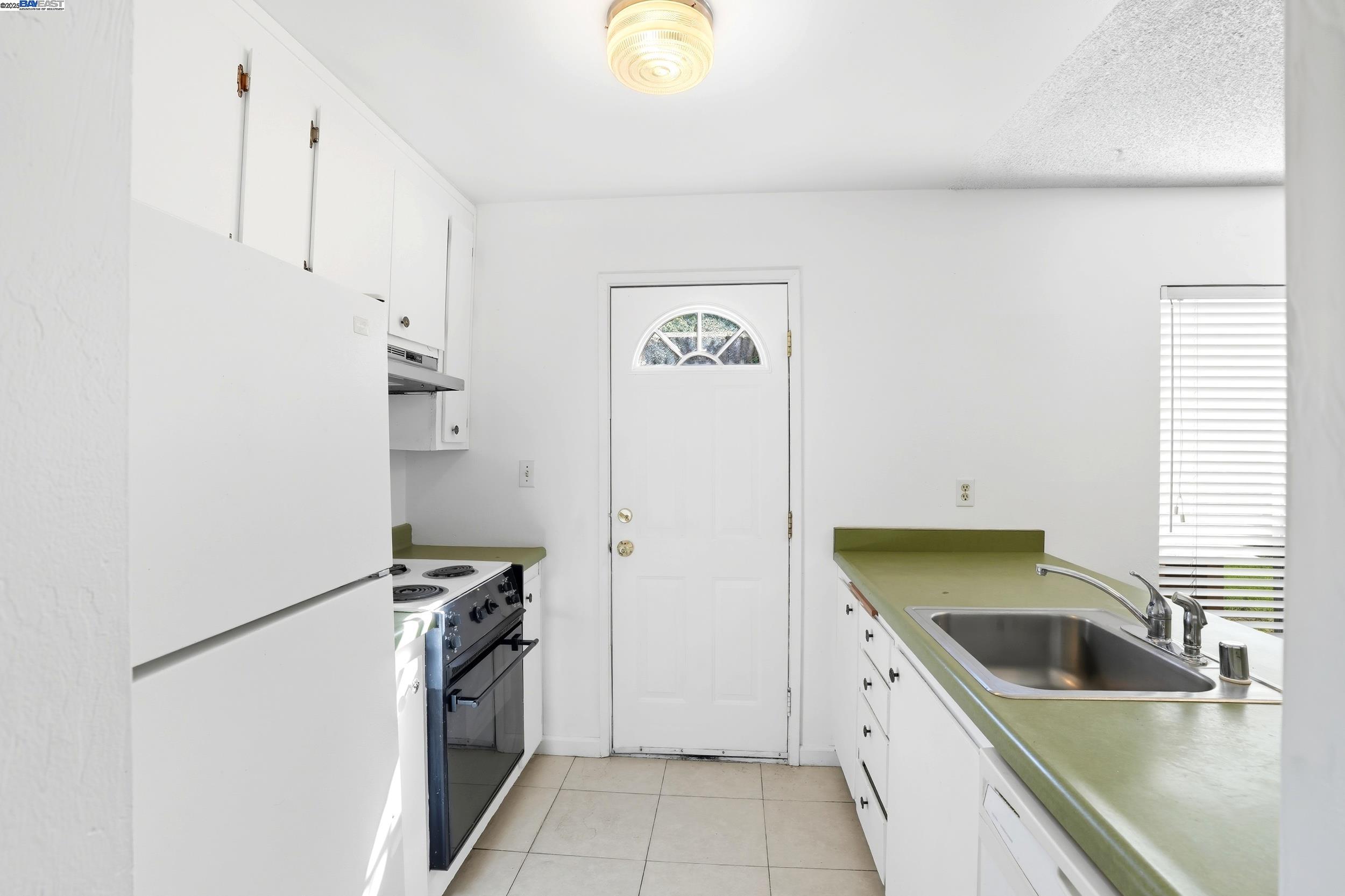 2067 Olivera Road, Unit B Concord, CA 94520 - Photo 6 of 23 a kitchen with a refrigerator and a sink