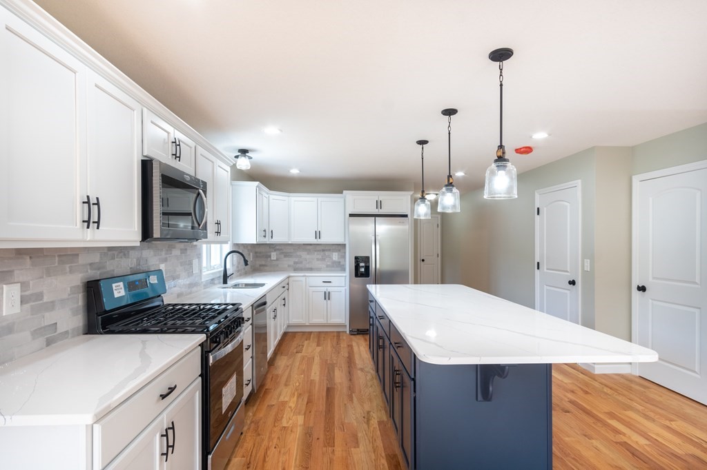 2 Upper Palmer Road Monson, MA 01057 - Photo 4 of 41 a kitchen with stainless steel appliances kitchen island granite countertop a sink stove and refrigerator