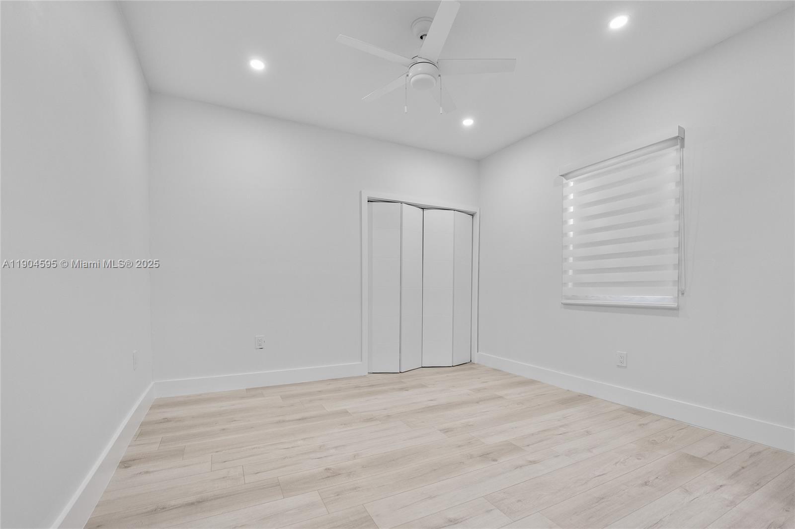 129 Southwest 9th Avenue, Unit 2 Miami, FL 33130 - Photo 12 of 16 wooden floor in an empty room with a window