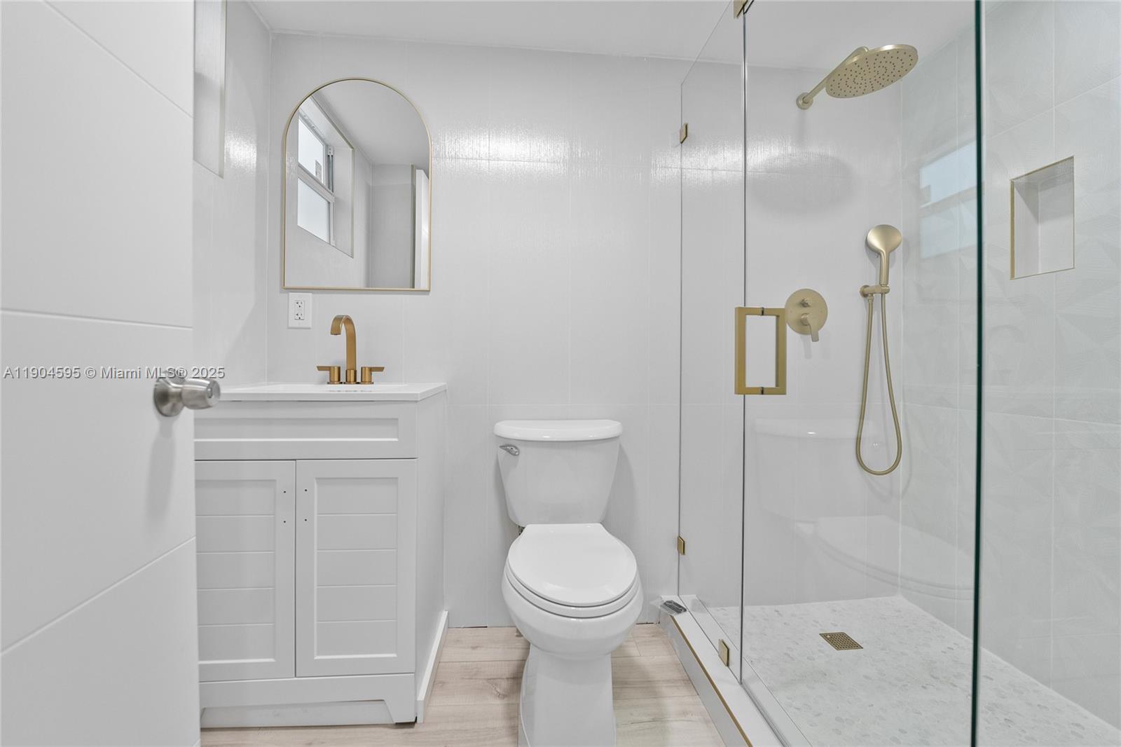 129 Southwest 9th Avenue, Unit 2 Miami, FL 33130 - Photo 16 of 16 a bathroom with a toilet sink vanity and shower