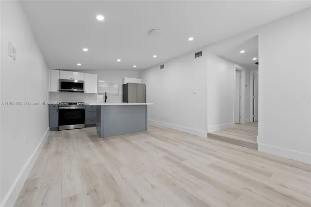 a view of kitchen appliances and cabinets