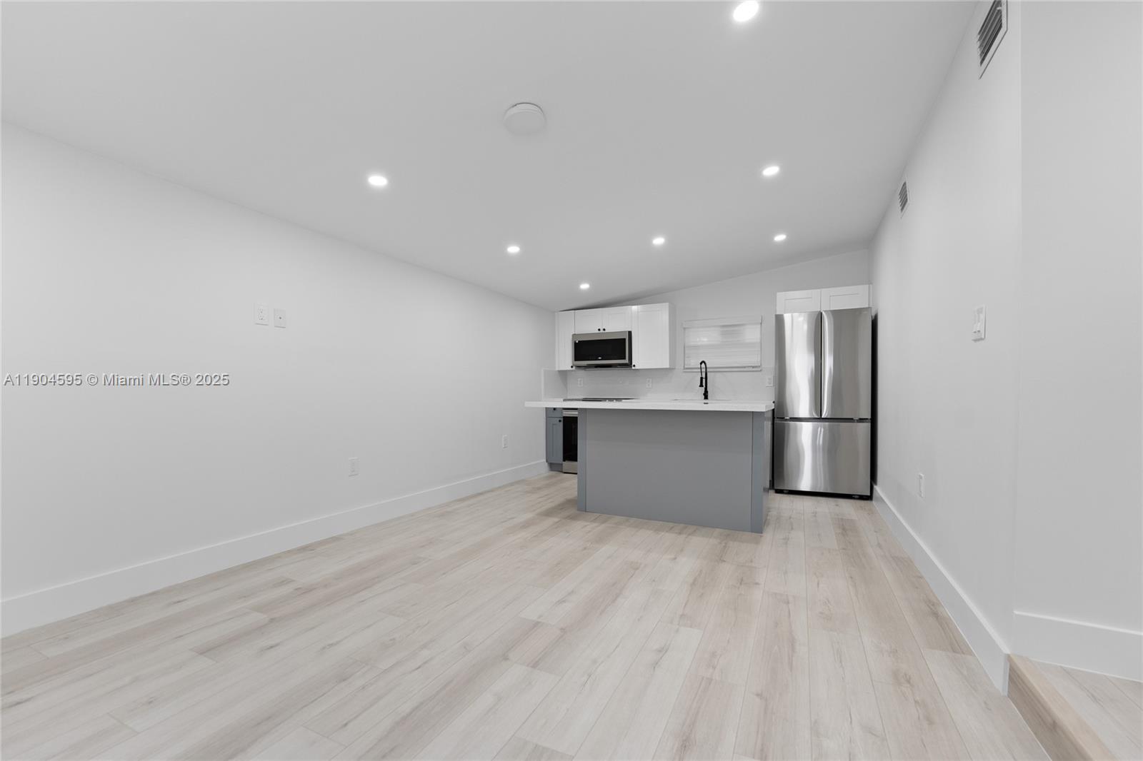 129 Southwest 9th Avenue, Unit 2 Miami, FL 33130 - Photo 3 of 16 a view of kitchen with wooden floor