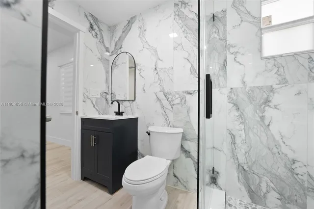 a bathroom with a sink toilet and shower