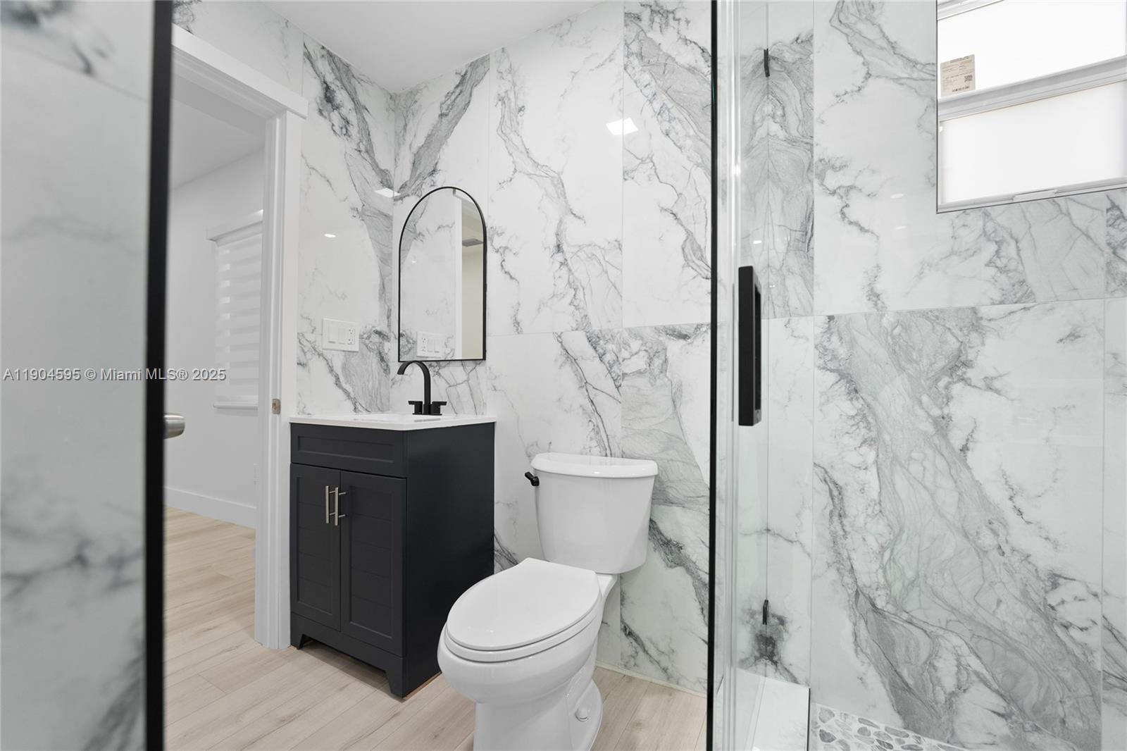 129 Southwest 9th Avenue, Unit 2 Miami, FL 33130 - Photo 7 of 16 a bathroom with a sink toilet and shower