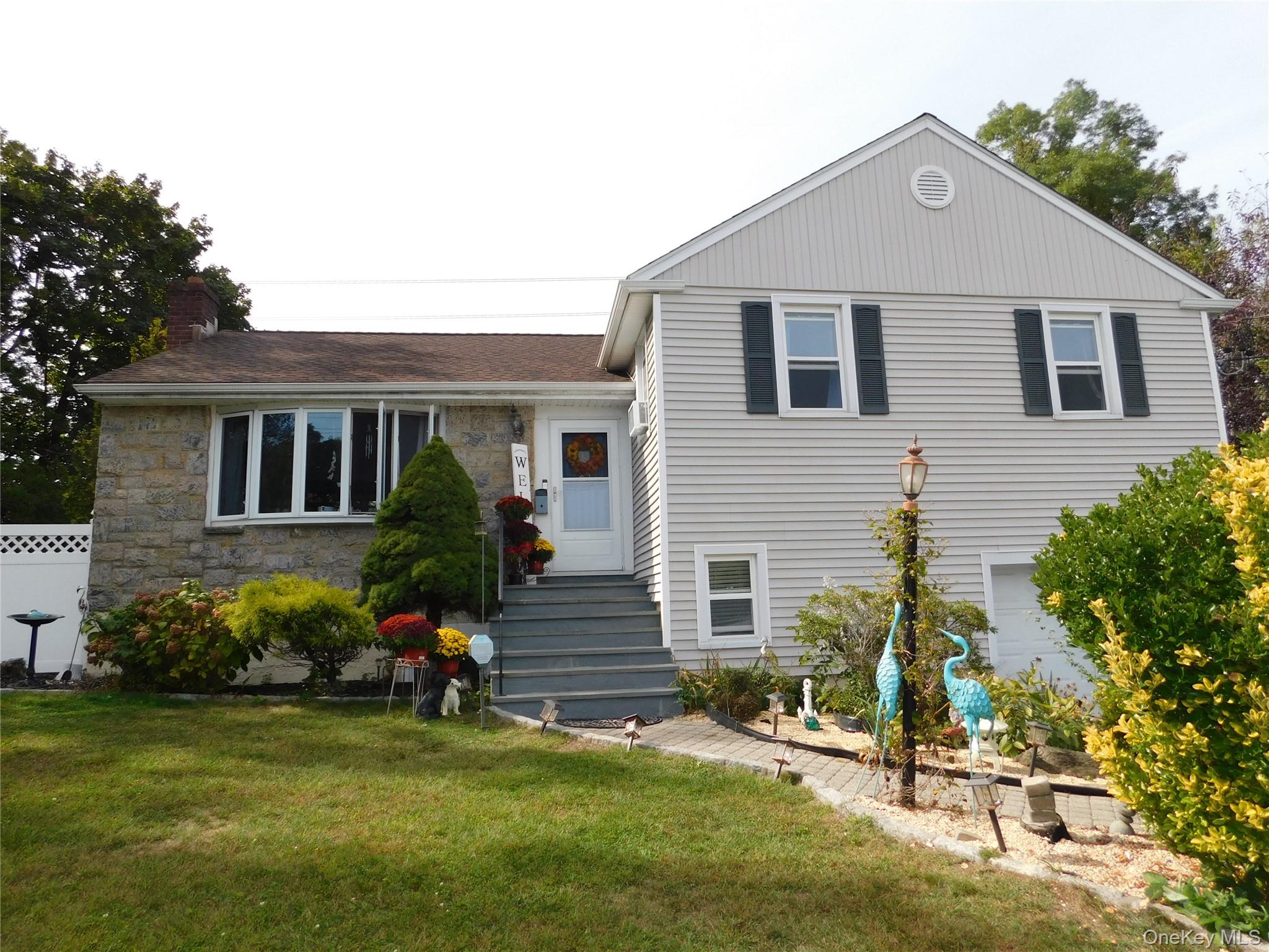 a front view of a house with a garden
