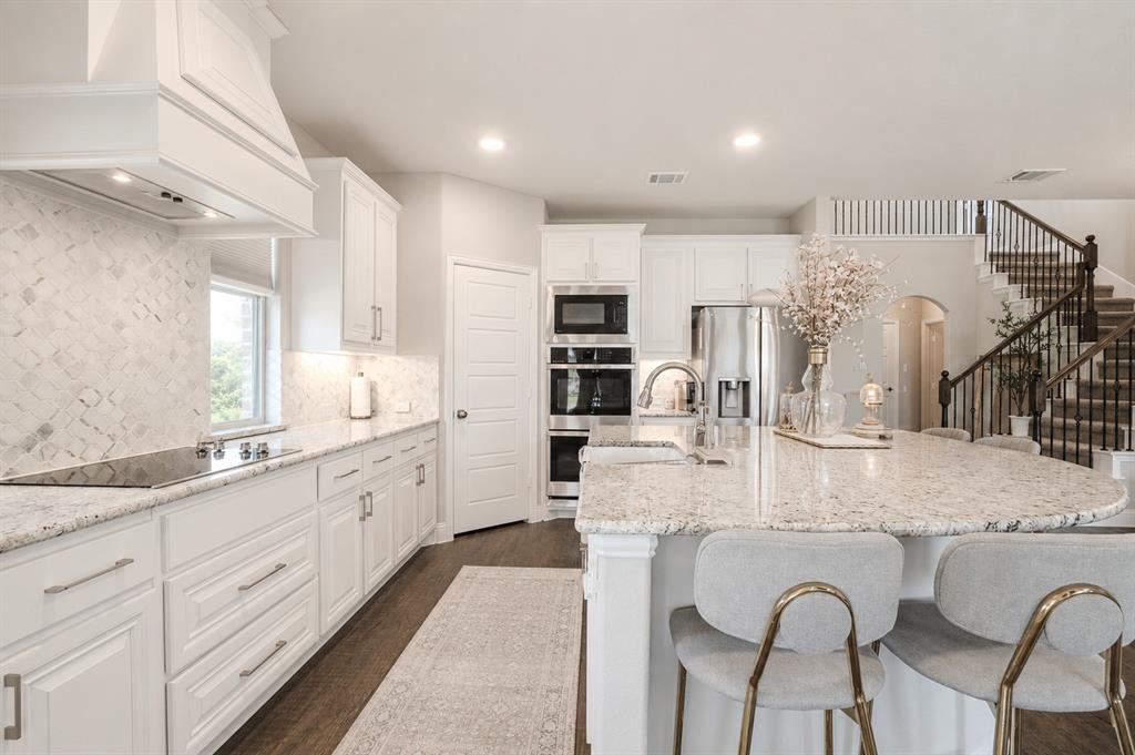 25 Morrison Road Howe, TX 75459 - Photo 7 of 27 Contemporary kitchen featuring white cabinetry, light-toned countertops, and a white tile backsplash