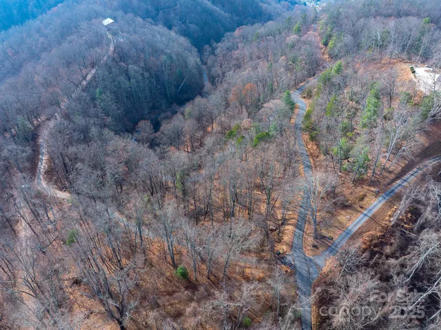 a view of a yard with wooden fence