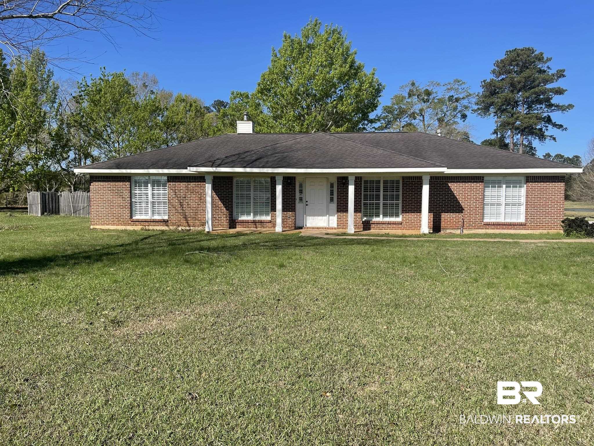 35405 Pine Road South Stapleton, AL 36578 - Photo 1 of 29 Single story home featuring brick siding, a front yard, a chimney, and a porch