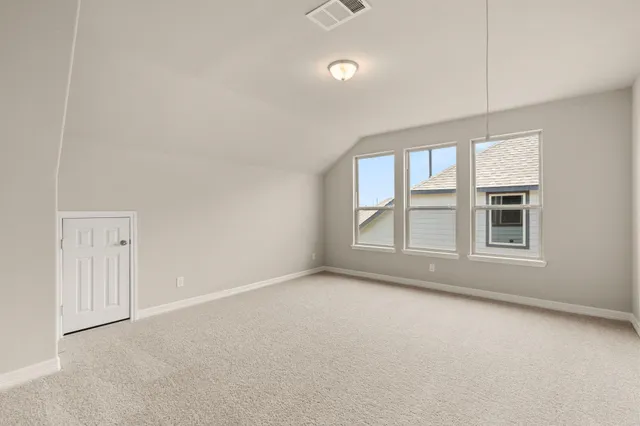 an empty room with windows and entrance