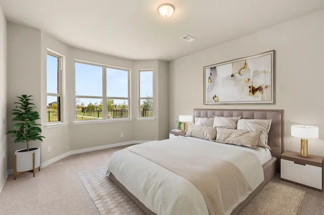 a bedroom with a large bed and a large window