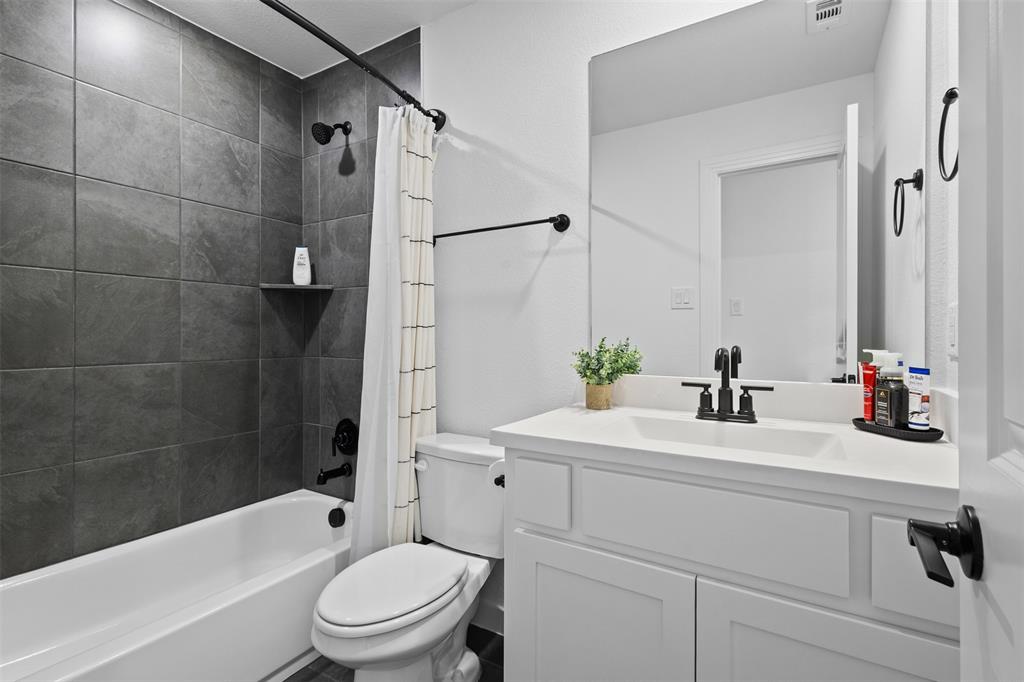 1825 Rough Rdg Trail Midlothian, TX 76065 - Photo 15 of 37 Modern bathroom featuring a white vanity with an integrated sink and matte black fixtures