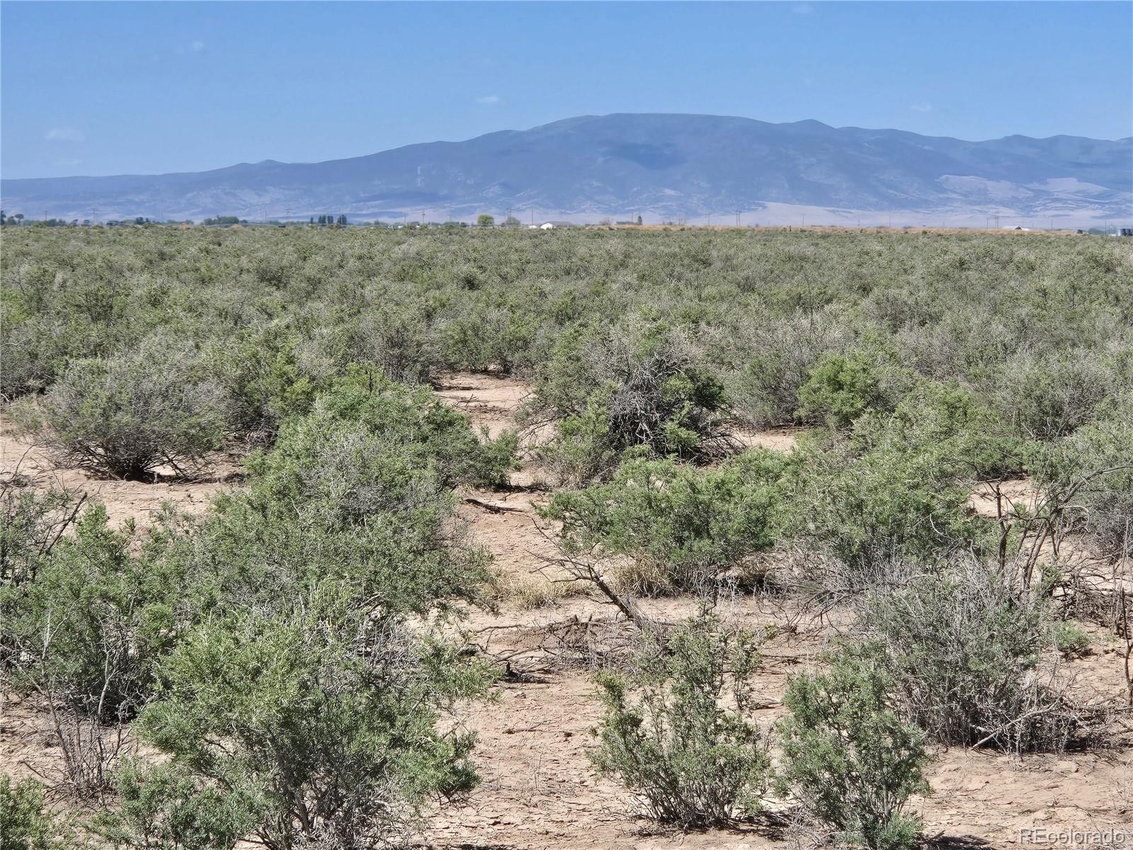 40 Acres Tbd Mosca, CO 81146 - Photo 12 of 13 a view of a lush green hillside and a houses