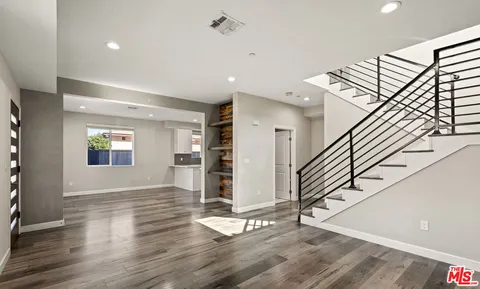 a view of an entryway with wooden floor and stairs