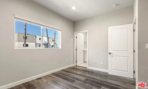 a view of a room with wooden floor and cabinet