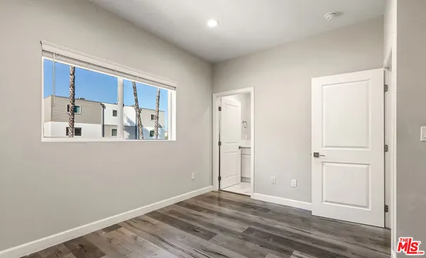 a view of a room with wooden floor and cabinet
