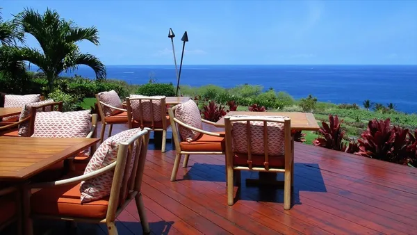 an outdoor sitting area with furniture and wooden floor