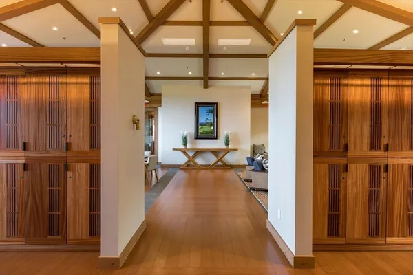 a view of a hallway with wooden floor and staircase