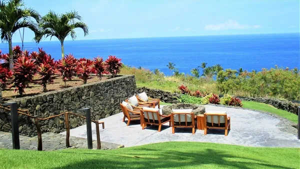 a view of a roof deck with couches and sky view