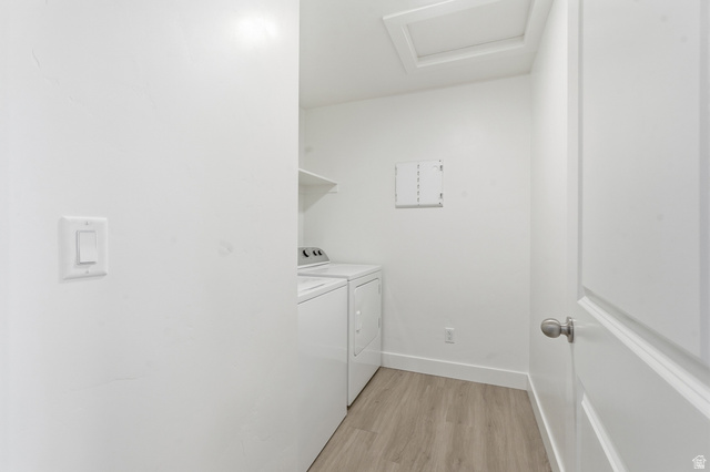 1173 West 1870 South Logan, UT 84321 - Photo 19 of 33 Dedicated laundry area featuring a washer and dryer, wood-finish flooring, and a white wall shelf