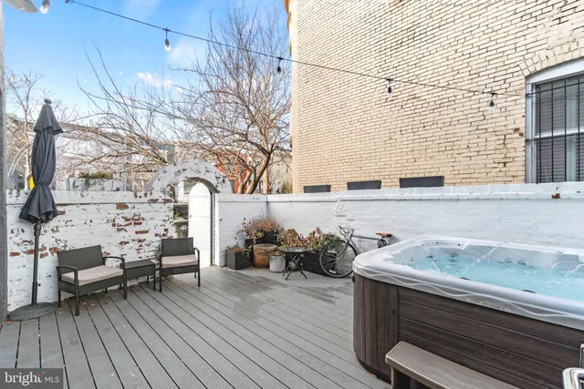 a view of a workspace with furniture and a bookshelf