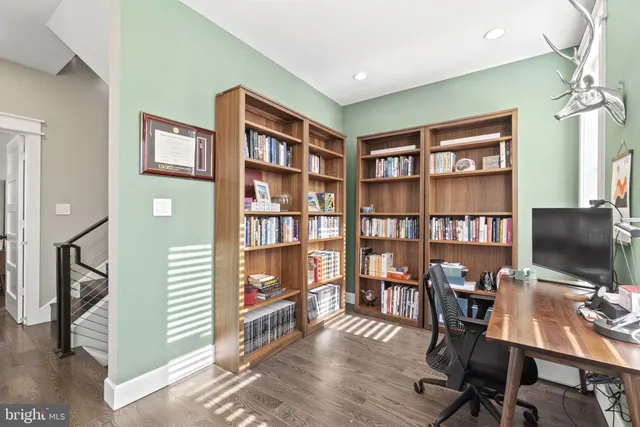 a living room with fireplace furniture and a large window