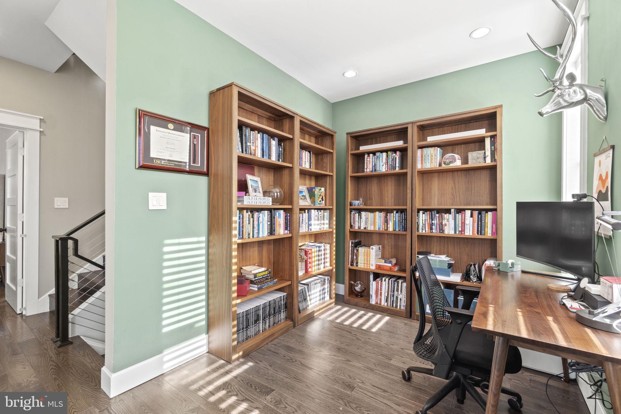 85 R Street Northwest Washington, DC 20001 - Photo 13 of 29 a view of a workspace with furniture and a bookshelf