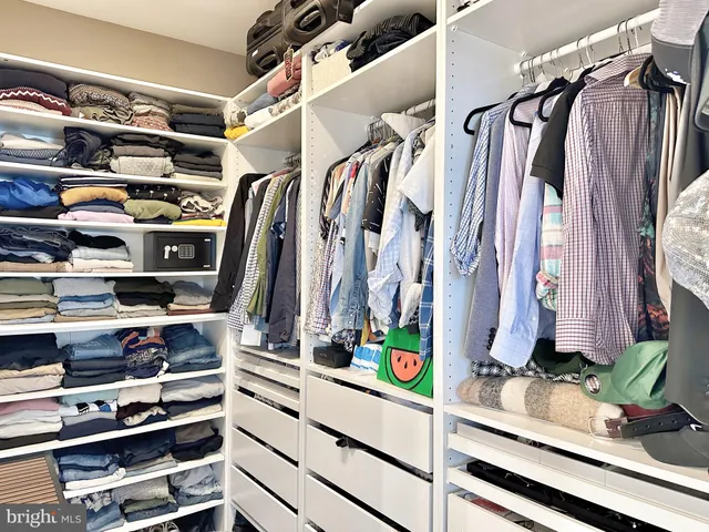 a bathroom with a double vanity sink a toilet a mirror and shower