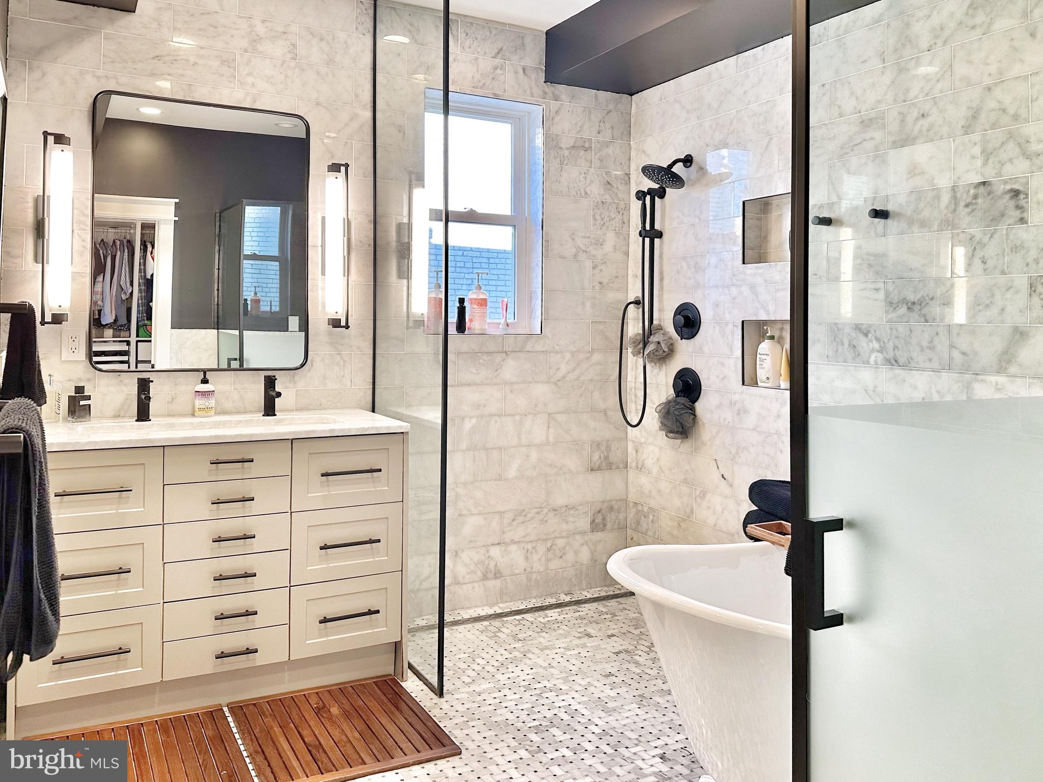 85 R Street Northwest Washington, DC 20001 - Photo 19 of 29 a bathroom with a double vanity sink a toilet a mirror and shower
