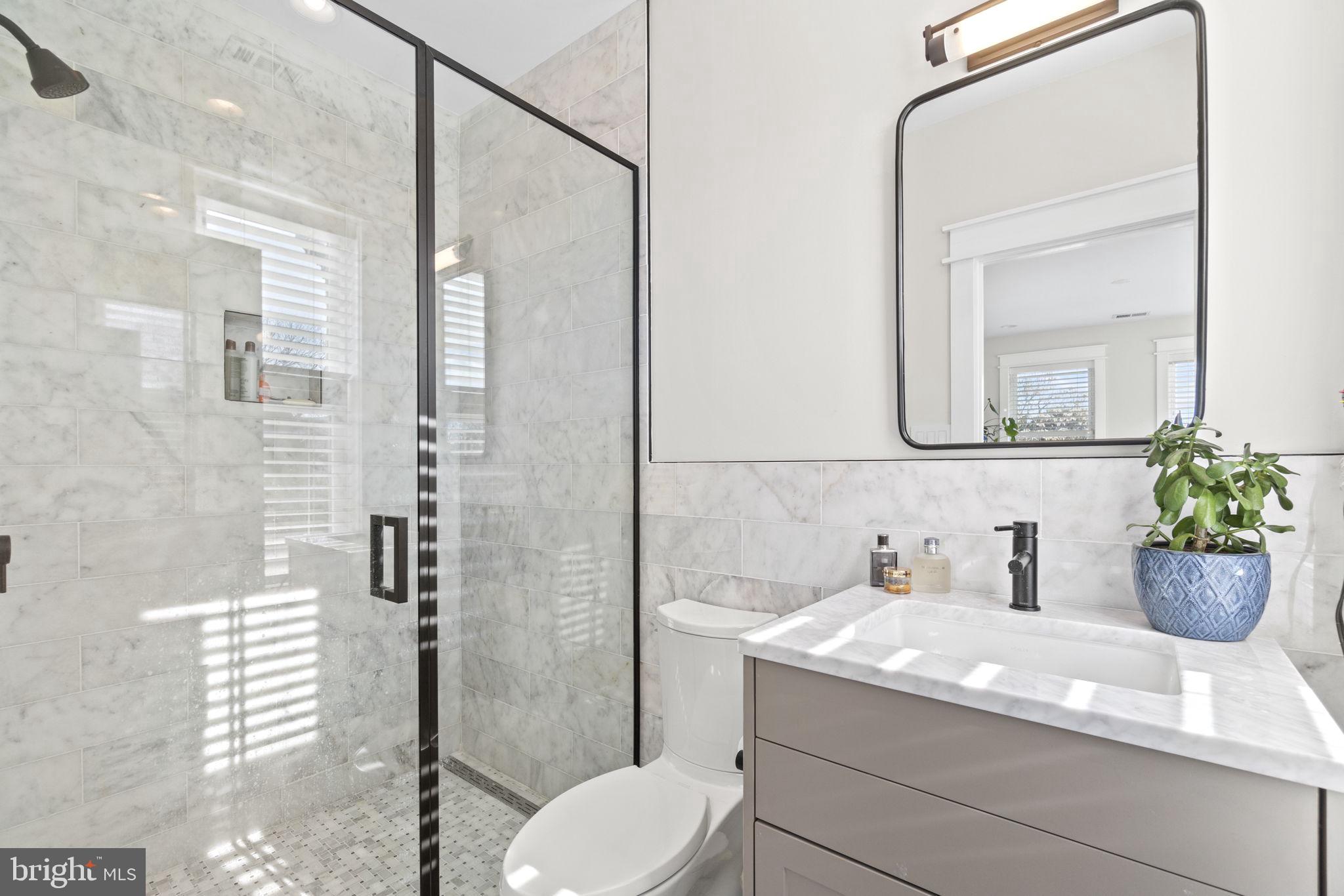 85 R Street Northwest Washington, DC 20001 - Photo 22 of 29 a bathroom with a granite countertop sink toilet and shower